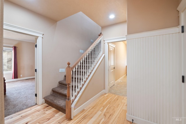 stairs featuring recessed lighting and wood finished floors