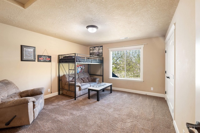 carpeted bedroom featuring visible vents, baseboards, and a textured ceiling
