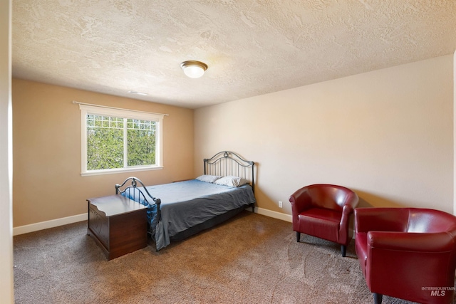 bedroom featuring baseboards, a textured ceiling, and carpet floors