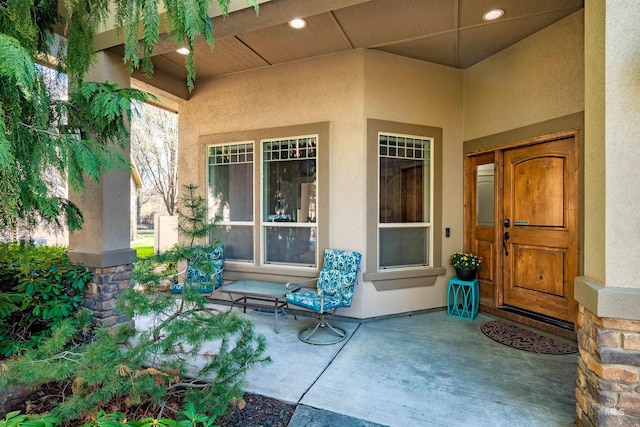 entrance to property featuring stucco siding