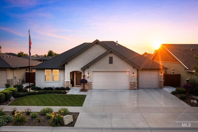 view of front of property with a yard and a garage