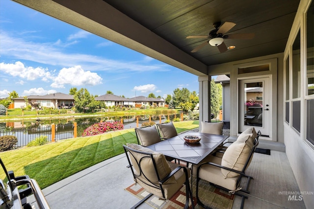 view of patio with ceiling fan and a water view