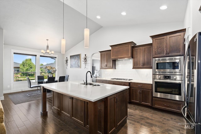 kitchen featuring sink, stainless steel appliances, an inviting chandelier, dark hardwood / wood-style flooring, and pendant lighting