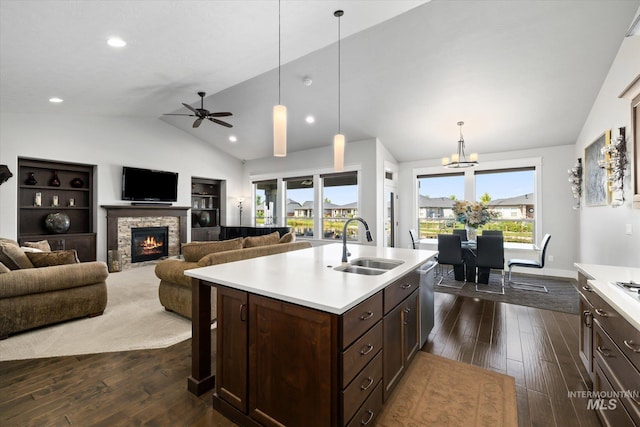 kitchen featuring dark hardwood / wood-style floors, lofted ceiling, a kitchen island with sink, and a wealth of natural light