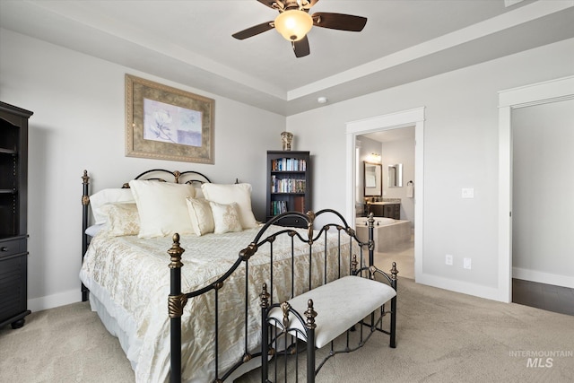 bedroom with connected bathroom, ceiling fan, and light colored carpet