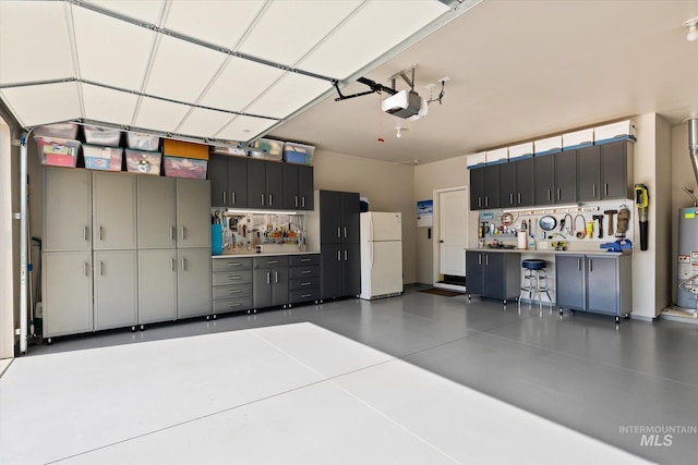 garage featuring a workshop area, white fridge, gas water heater, and a garage door opener