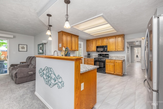 kitchen featuring black appliances, a peninsula, light countertops, a textured ceiling, and open floor plan