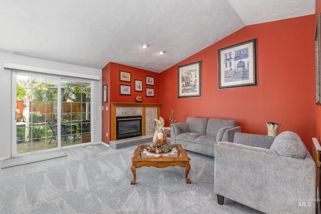 carpeted living area with lofted ceiling, a tiled fireplace, and baseboards