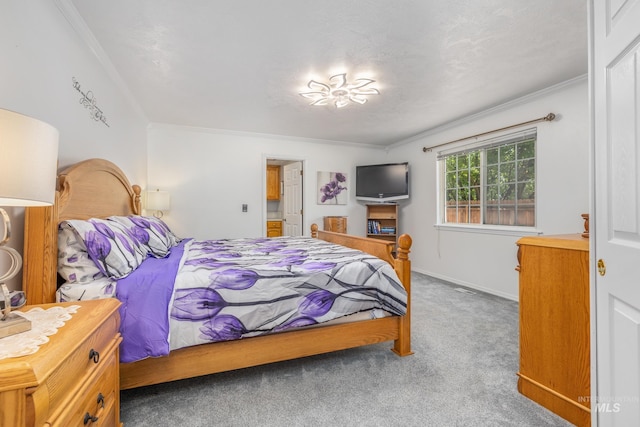 carpeted bedroom featuring crown molding and baseboards