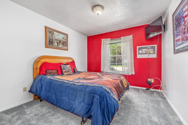 bedroom with carpet floors, baseboards, and a textured ceiling