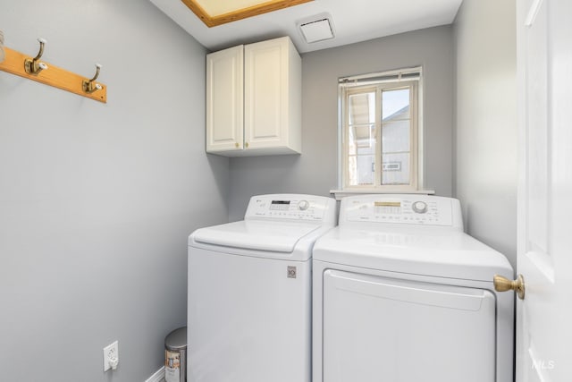 washroom with washing machine and dryer and cabinet space