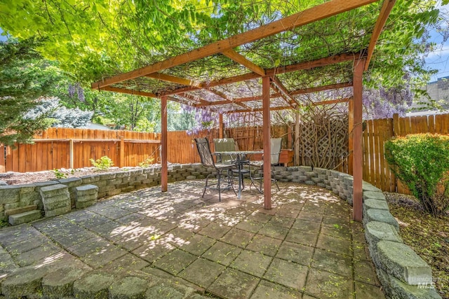 view of patio / terrace featuring a pergola, outdoor dining space, and a fenced backyard