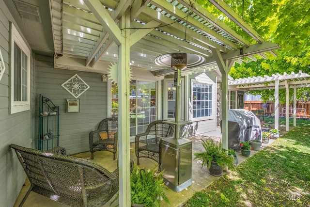 view of patio with a pergola and fence