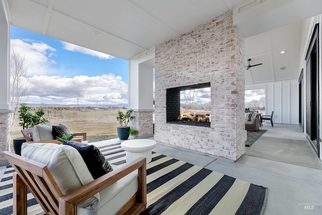 view of patio with an outdoor living space with a fireplace
