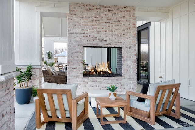 view of patio / terrace with an outdoor living space with a fireplace
