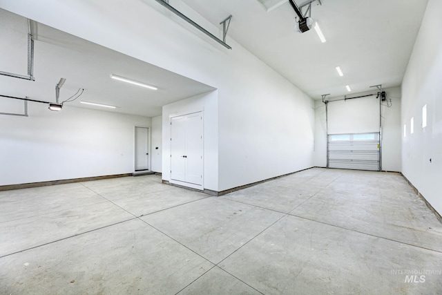 garage featuring a garage door opener and baseboards