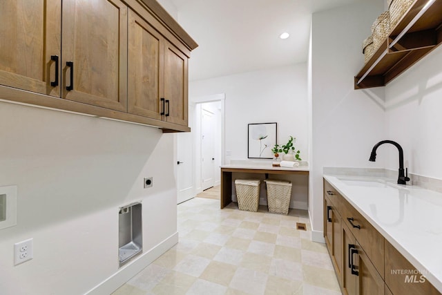 washroom with a sink, light floors, recessed lighting, cabinet space, and hookup for an electric dryer