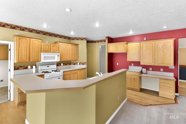 kitchen with white appliances, a large island, light brown cabinets, light wood-style flooring, and recessed lighting