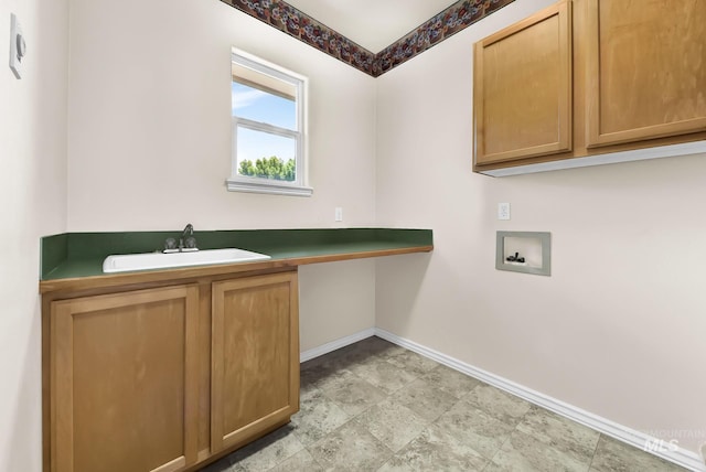 laundry area with washer hookup, baseboards, and cabinet space