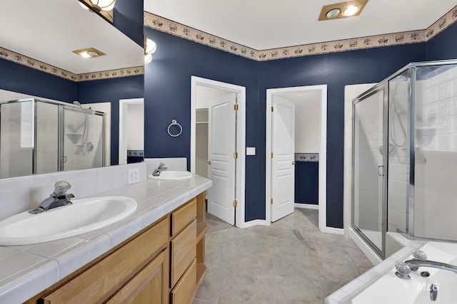 bathroom featuring a stall shower and double vanity