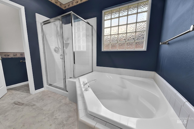 full bathroom with a stall shower and a garden tub