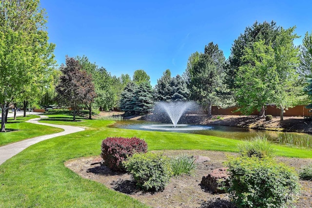 surrounding community featuring a water view and a yard