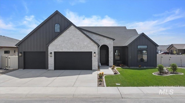 1948 Red Rock Way, Twin Falls, ID 83301 - view of front of home featuring board and batten siding, a gate, concrete driveway, and stone siding