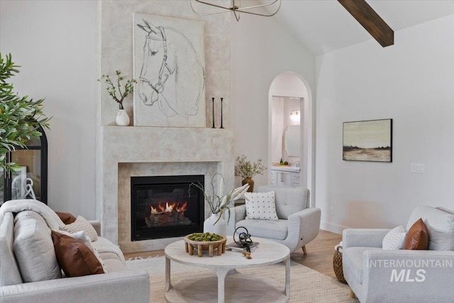 1948 Red Rock Way, Twin Falls, ID 83301 - living room featuring wood finished floors, beam ceiling, arched walkways, high vaulted ceiling, and a high end fireplace