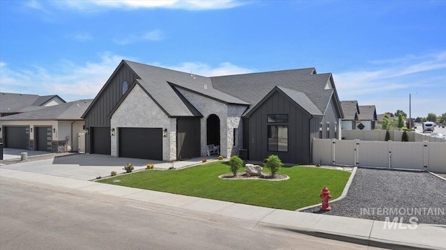 1948 Red Rock Way, Twin Falls, ID 83301 - view of front of property with board and batten siding, a gate, an attached garage, and driveway