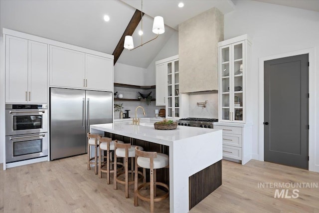 1948 Red Rock Way, Twin Falls, ID 83301 - kitchen with stainless steel appliances, open shelves, white cabinetry, a center island with sink, and high vaulted ceiling