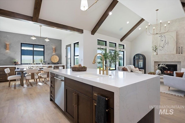 1948 Red Rock Way, Twin Falls, ID 83301 - kitchen with light wood-style flooring, hanging light fixtures, beamed ceiling, dark brown cabinets, and stainless steel dishwasher