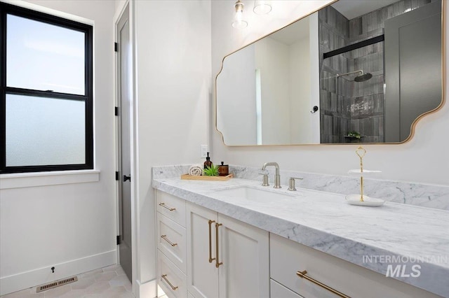 1948 Red Rock Way, Twin Falls, ID 83301 - bathroom with vanity, tiled shower, and tile patterned floors