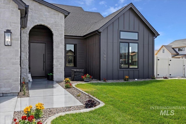 1948 Red Rock Way, Twin Falls, ID 83301 - view of front of property featuring board and batten siding, a gate, stone siding, and a shingled roof