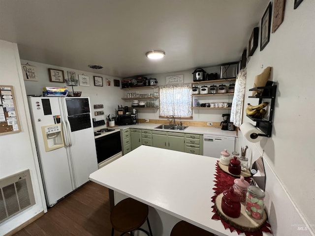 kitchen with light countertops, white appliances, green cabinetry, and open shelves