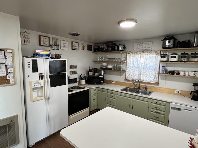 kitchen with open shelves, light countertops, green cabinets, a sink, and white appliances