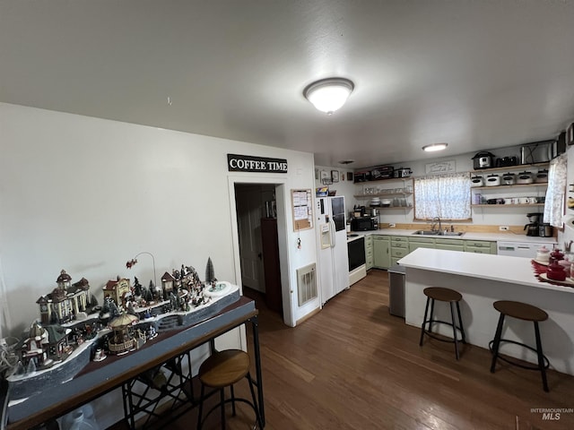 kitchen featuring white appliances, dark wood finished floors, light countertops, open shelves, and green cabinetry