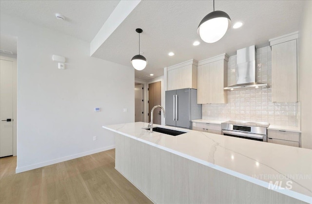 4340 E Haystack St Unit 101, Boise, ID 83716 - kitchen with wall chimney range hood, high end fridge, a sink, backsplash, and light wood-type flooring