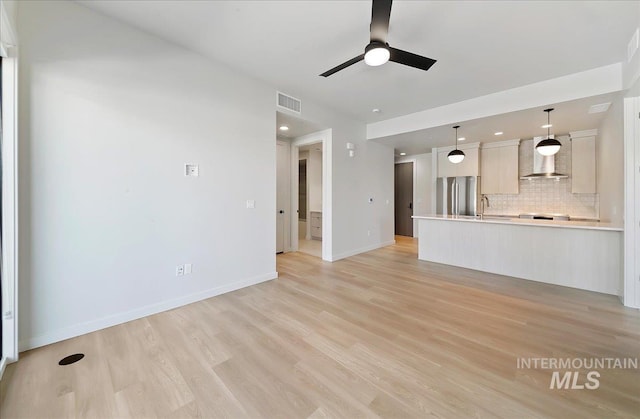 4340 E Haystack St Unit 101, Boise, ID 83716 - unfurnished living room with ceiling fan, light wood-type flooring, baseboards, recessed lighting, and a sink