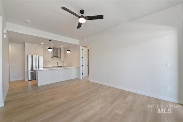 4340 E Haystack St Unit 101, Boise, ID 83716 - unfurnished living room featuring light wood-type flooring, ceiling fan, baseboards, a sink, and recessed lighting