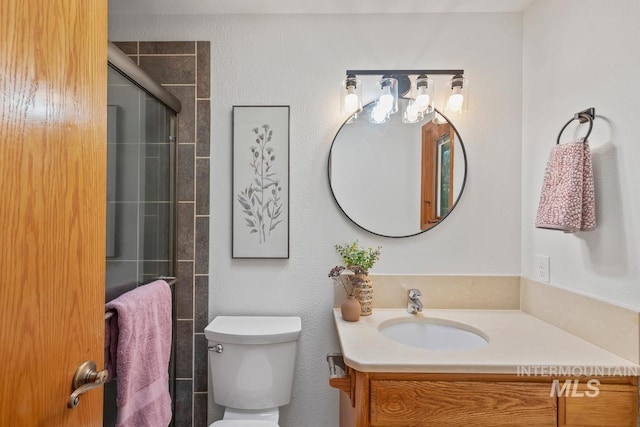 9421 W Rifleman St, Boise, ID 83703 - bathroom featuring vanity, toilet, and a tile shower
