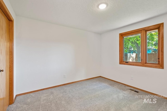 9421 W Rifleman St, Boise, ID 83703 - carpeted spare room with baseboards and a textured ceiling