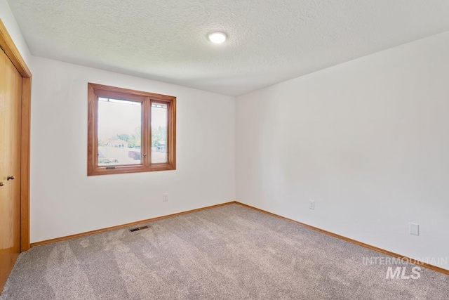 9421 W Rifleman St, Boise, ID 83703 - spare room featuring carpet floors, a textured ceiling, and baseboards