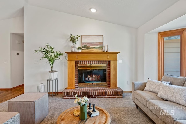 9421 W Rifleman St, Boise, ID 83703 - carpeted living room with lofted ceiling, a fireplace, and baseboards