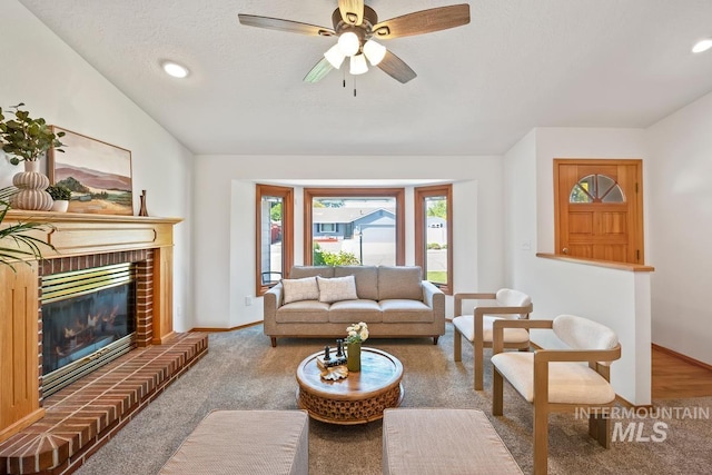 9421 W Rifleman St, Boise, ID 83703 - carpeted living area featuring baseboards, a brick fireplace, a ceiling fan, recessed lighting, and a textured ceiling