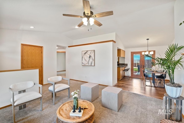 9421 W Rifleman St, Boise, ID 83703 - carpeted living room with vaulted ceiling, a ceiling fan, a chandelier, baseboards, and wood finished floors