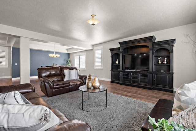 11153 W Brett Dr, Nampa, ID 83686 - living room featuring a chandelier, wood finished floors, baseboards, and a textured ceiling