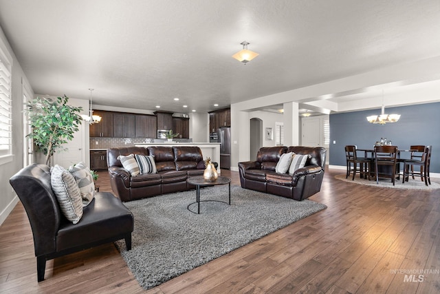11153 W Brett Dr, Nampa, ID 83686 - living room featuring a chandelier, hardwood / wood-style flooring, baseboards, and recessed lighting