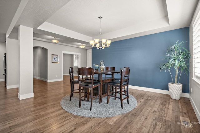 11153 W Brett Dr, Nampa, ID 83686 - dining area featuring a raised ceiling, a chandelier, and wood finished floors