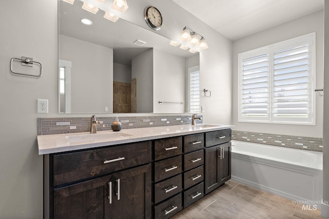 11153 W Brett Dr, Nampa, ID 83686 - bathroom featuring double vanity, backsplash, and a bath