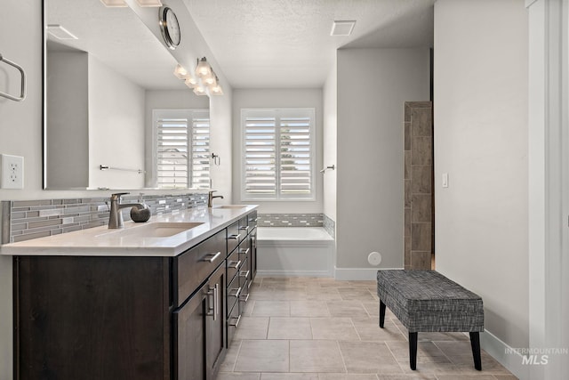 11153 W Brett Dr, Nampa, ID 83686 - full bath with a garden tub, double vanity, backsplash, and a textured ceiling